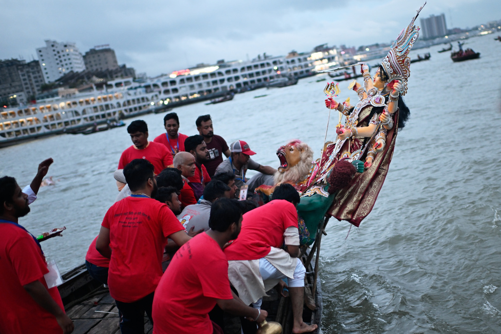 Devotees carry an idol of the Hindu goddess Durga in a boat for immersion in the Buriganga River marking the end of Durga Puja in Dhaka, Bangladesh, Thursday, Oct. 2, 2025. (AP Photo/Mahmud Hossain Opu)