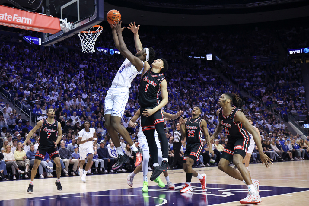 BYU forward AJ Dybantsa (3) goes to the basket against Houston guard Isiah Harwell (1) during the first half of an NCAA college basketball game, Saturday, Feb. 7, 2026, in Provo, Utah. (AP Photo/Rob Gray)