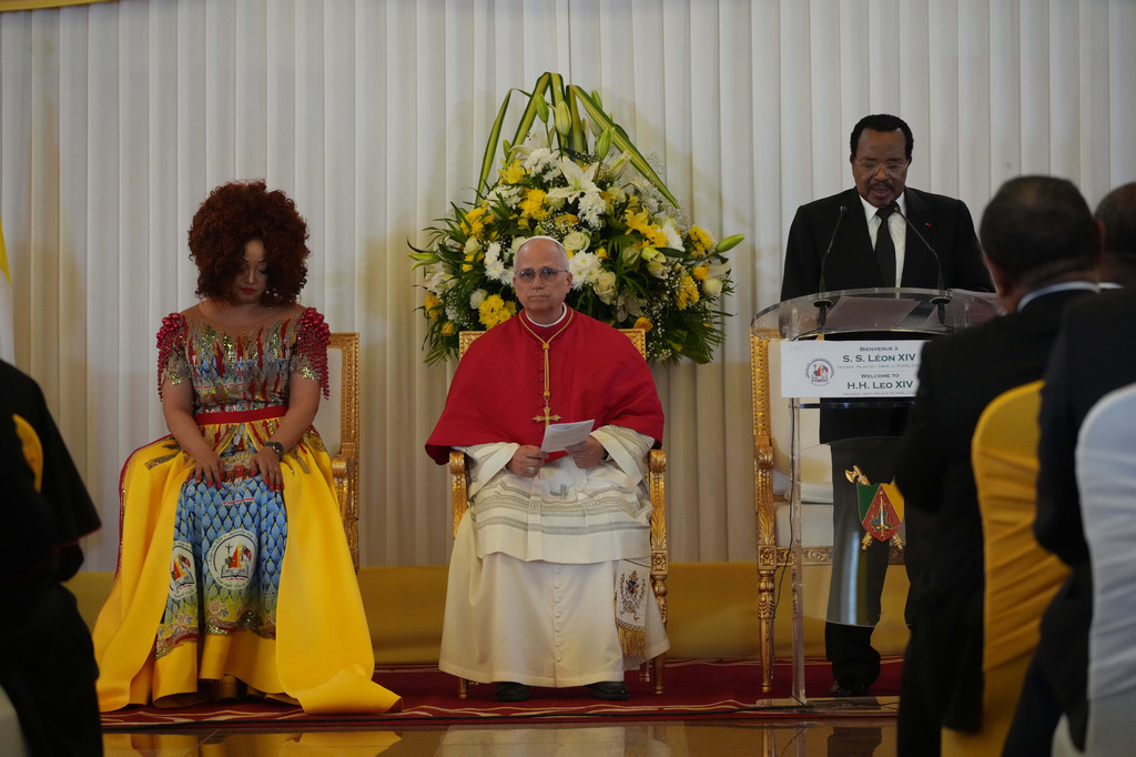 Cameroon's President Paul Biya, right, flanked by Pope Leo XIV, center, fand his wife Chantal, delivers his speech during the meeting with the authorities, civil society and the diplomatic corps in Yaounde Cameroon, Wednesday, April 15, 2026. (AP Photo/Andrew Medichini)