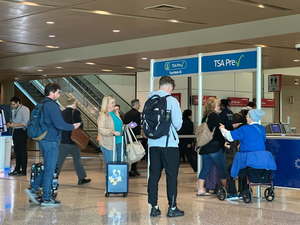 People walk through TSA PreCheck at Dallas Love Field on Sunday, Feb. 22, 2026. (AP Photo/Jamie Stengle)