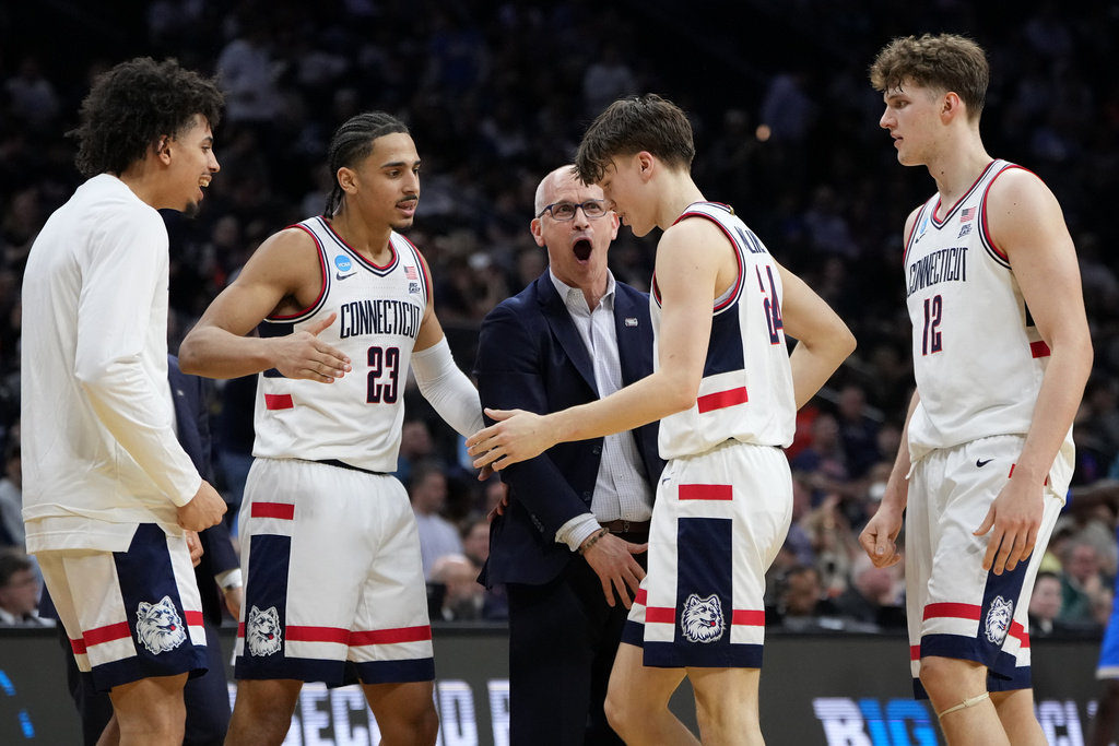 UConn's Dan Hurley celebrates with Braylon Mullins during the first half against UCLA in the second round of the NCAA college basketball tournament, Sunday, March 22, 2026, in Philadelphia. (AP Photo/Matt Slocum)