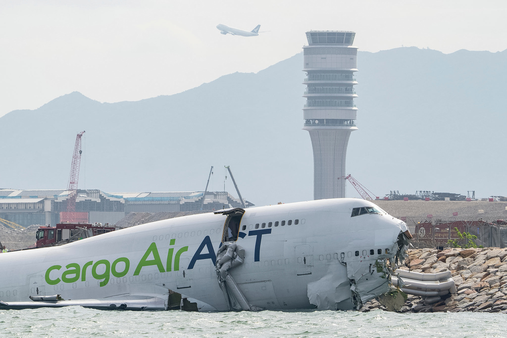 The cargo aircraft that skidded off a Hong Kong airport runway is seen on Monday, Oct. 20, 2025. (AP Photo/Chan Long Hei)