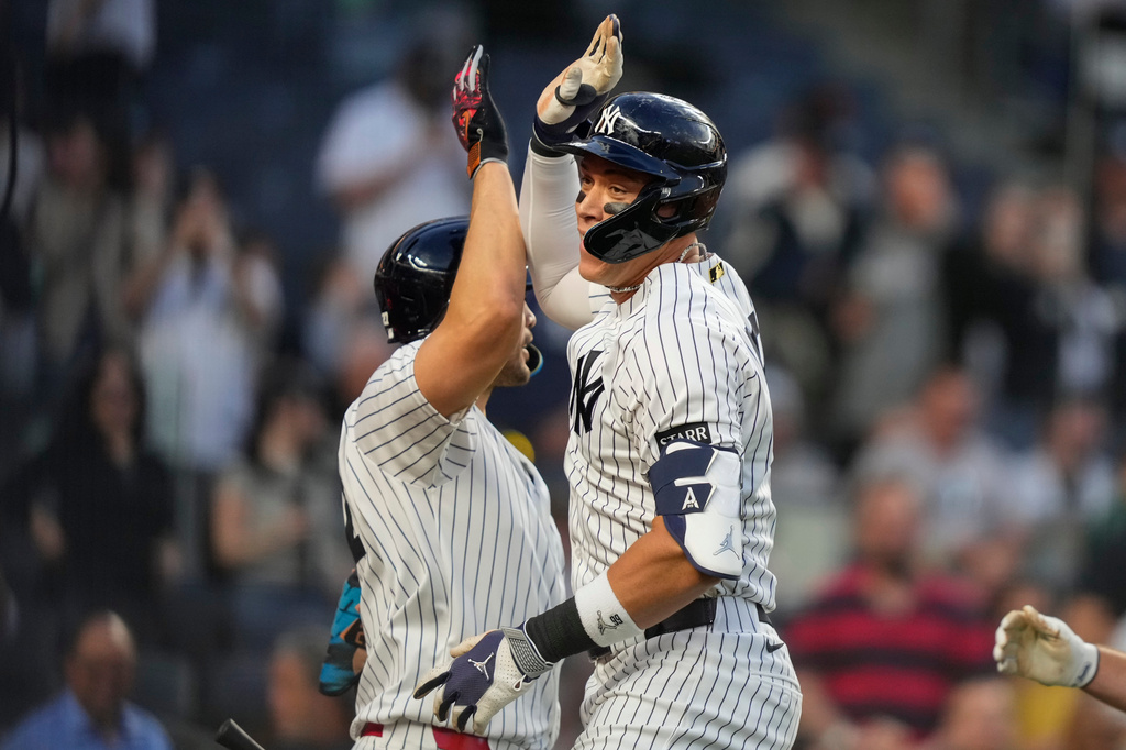 New York Yankees' Aaron Judge, right, celebrates with designated hitter Giancarlo Stanton, left, after hitting a two-run home run during the first inning of a baseball game against the Los Angeles Angels, Monday, April 13, 2026, in New York. (AP Photo/Yuki Iwamura)