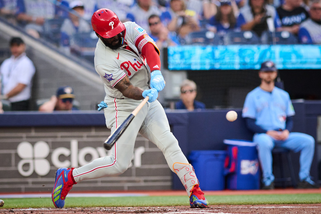 Philadelphia Phillies' Adolis Garcia hits a two-run home run against the Toronto Blue Jays during second-inning baseball game action in Toronto, Monday, June 8, 2026. (Sammy Kogan/The Canadian Press via AP)
