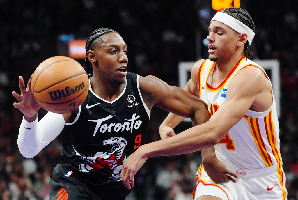Toronto Raptors' RJ Barrett (9) drives past Atlanta Hawks' Asa Newell (14) during the first half of an NBA basketball game in Toronto, Saturday, Jan. 3, 2026. (Frank Gunn/The Canadian Press via AP)