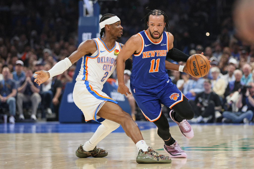 New York Knicks guard Jalen Brunson (11) drives against Oklahoma City Thunder guard Shai Gilgeous-Alexander (2) during the first half of an NBA basketball game Sunday, March 29, 2026, in Oklahoma City. (AP Photo/Nate Billings)