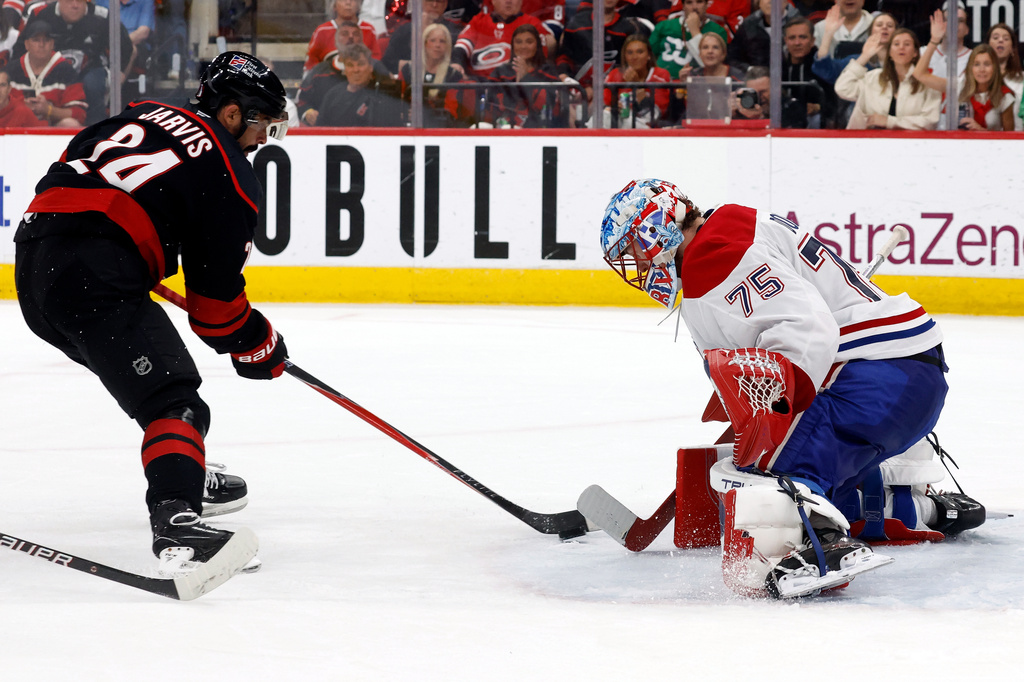Carolina Hurricanes' Seth Jarvis (24) has his shot blocked by Montréal Canadiens goaltender Jakub Dobes (75) during the second period in Game 1 of the Eastern Conference finals NHL hockey Stanley Cup playoffs series in Raleigh, N.C., Thursday, May 21, 2026. (AP Photo/Karl DeBlaker)