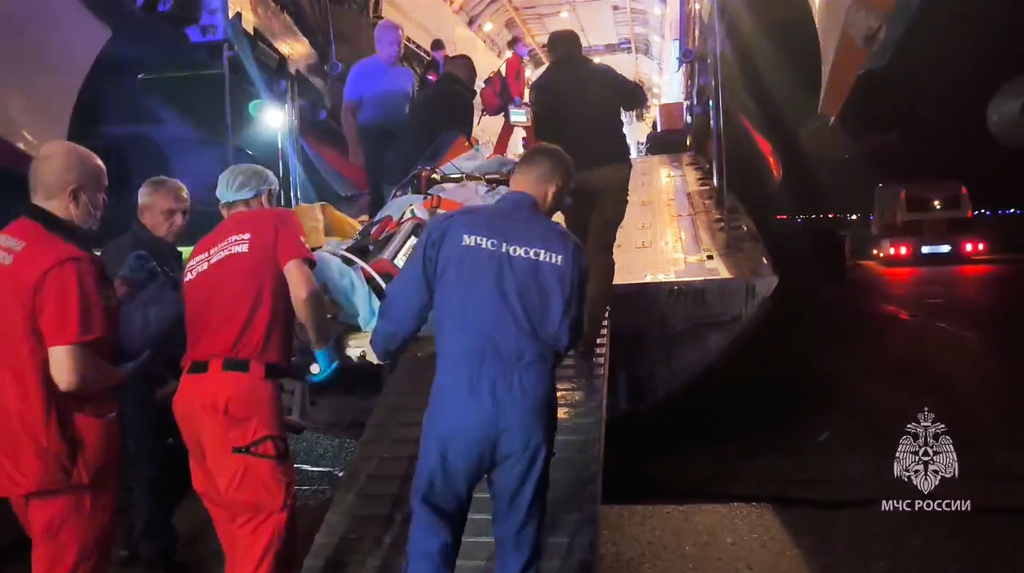 In this image made from video provided by Russian Emergency Situations Ministry press service, medical and rescue workers put those injured in a fire at the Amur Gas Chemical Complex on a plane to Moscow in Blagoveschensk, Amur region, Russia, Thursday, Aug. 27, 2026. (Ministry of Emergency Situations press service via AP)