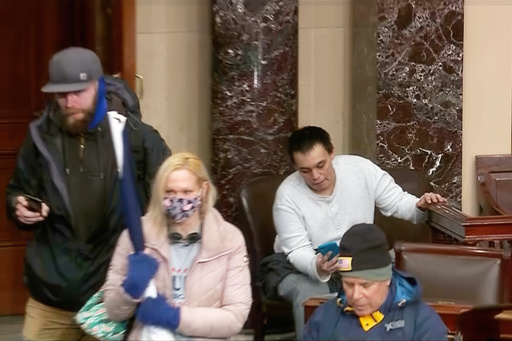 This image from Senate Television shows Christopher Moynihan looking at his mobile device as he sits in the Senate Chamber at the U.S. Capitol in Washington, Jan. 6, 2021. (Senate Television via AP) This image from Senate Television shows Christopher Moynihan looking at his mobile device as he sits in the Senate Chamber at the U.S. Capitol in Washington, Jan. 6, 2021. (Senate Television via AP)
