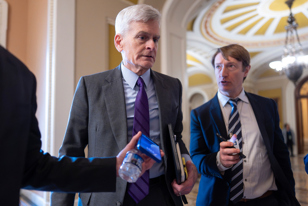 Sen. Bill Cassidy, R-La., chairman of the Senate Health, Education, Labor and Pensions (HELP) Committee, strives for a closed-door meeting with fellow Republicans at the Capitol in Washington, Tuesday, Dec. 9, 2025. (AP Photo/J. Scott Applewhite)