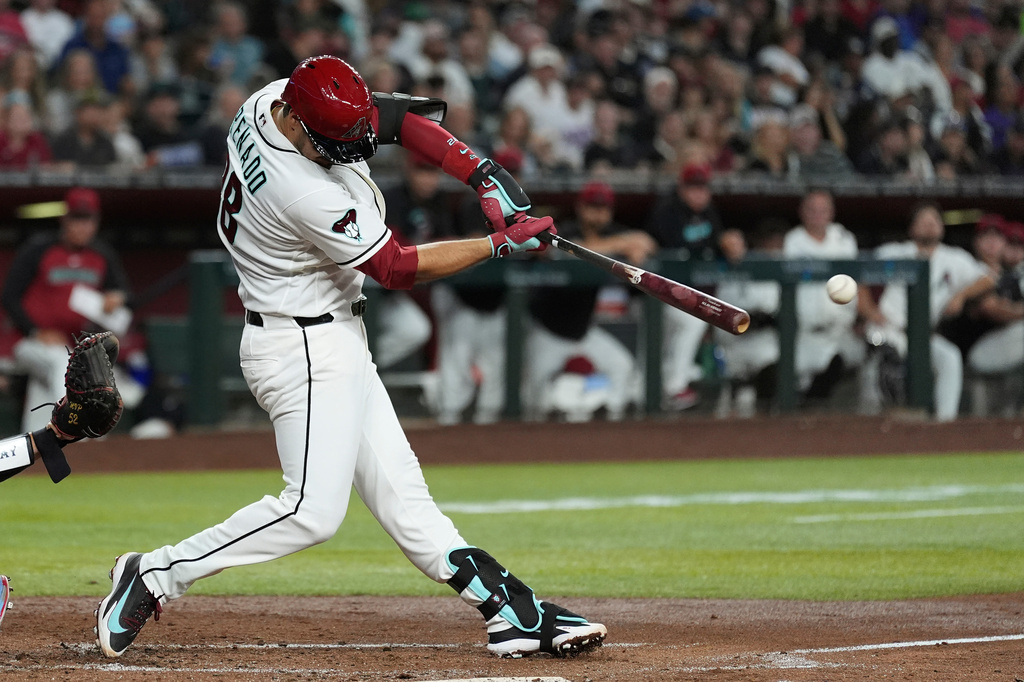 Arizona Diamondbacks' Nolan Arenado connects on a two-run double against the St. Louis Cardinals during the third inning of a baseball game, Saturday, July 18, 2026, in Phoenix. (AP Photo/Ross D. Franklin)
