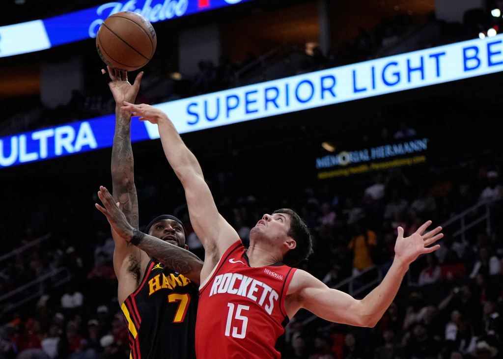 Atlanta Hawks guard Nickeil Alexander-Walker (7) shoots against Houston Rockets guard Reed Sheppard (15) during the first half of an NBA basketball game in Houston, Friday, March 20, 2026. (AP Photo/Ashley Landis)