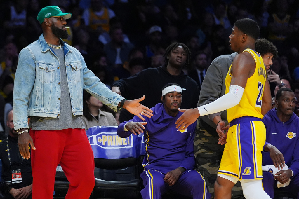 Los Angeles Lakers forward LeBron James (23) greets Los Angeles Lakers forward Rui Hachimura (28) after returning to the bench during the first half of an NBA basketball game Monday, Oct. 27, 2025, in Los Angeles. (AP Photo/Ethan Swope)