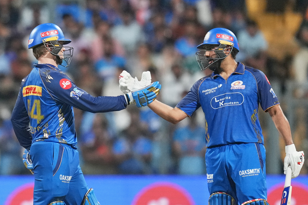Mumbai Indians' Ryan Rickelton, left, celebrates his fifty runs with Rohit Sharma during the Indian Premier League cricket match between Mumbai Indians and Lucknow Super Giants in Mumbai, India, Monday, May 4, 2026.(AP Photo/Rafiq Maqbool)