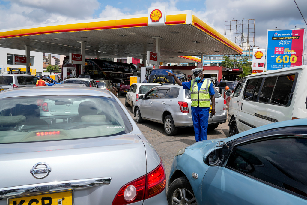FILE - A policeman directs motorists queueing to buy gasoline at one of the gas stations with fuel still available for sale, in the Hurlingham neighborhood of the capital Nairobi, Kenya, on April 14, 2022. (AP Photo/Khalil Senosi, File)