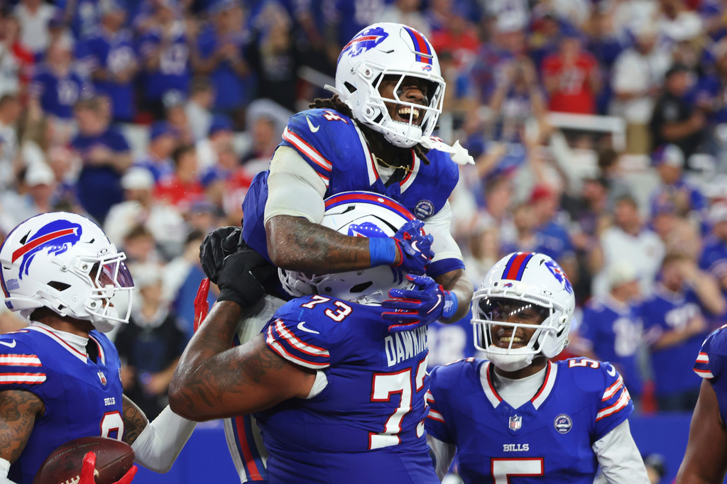 Buffalo Bills running back James Cook (4) celebrates his rushing touchdown against the Detroit Lions during the second half of an NFL football game in Orchard Park, N.Y., Thursday, Sept. 17, 2026. (AP Photo/Jeffrey T. Barnes )