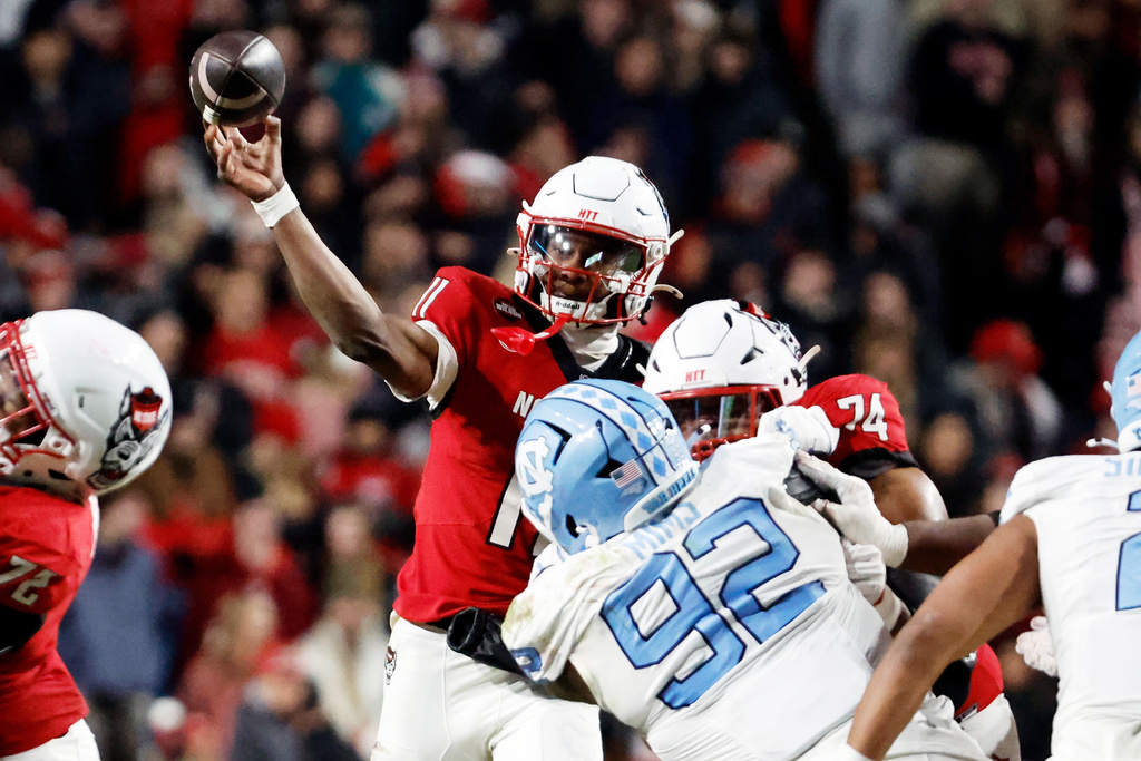 North Carolina State quarterback CJ Bailey (11) passes the ball against North Carolina during the first half of an NCAA college football game in Raleigh, N.C., Saturday, Nov. 29, 2025. (AP Photo/Karl DeBlaker)