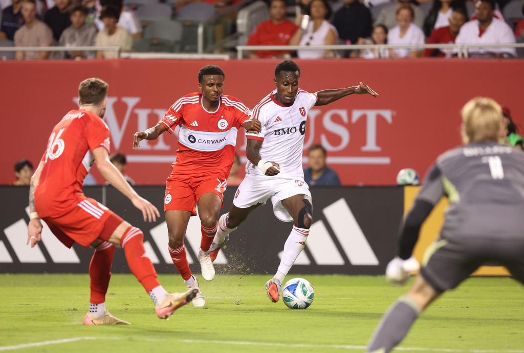 Chicago Fire midfielder Maren Haile-Selassie, center left, and Toronto FC defender Richie Laryea, center right, battle for control of the ball during the second half of an MLS soccer match Saturday, Oct. 4, 2025, in Chicago. (AP Photo/Talia Sprague)