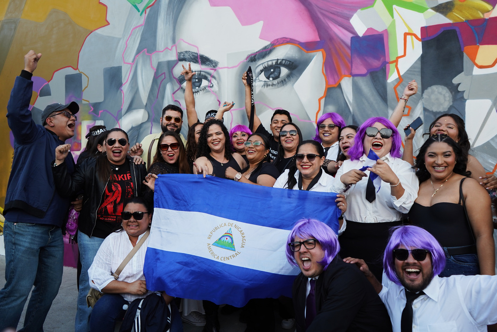Fans of Colombian pop star Shakira pose for a photo with a Nicaraguan flag before her concert at the National Stadium in San Salvador, El Salvador, Thursday, Feb. 12, 2026. (AP Photo/Salvador Melendez)