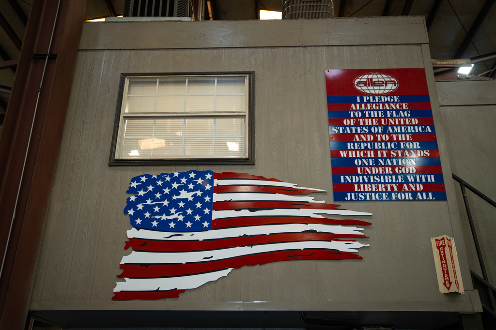 An American flag and the Pledge of Allegiance is seen inside the Allen Engineering Corporation plant Monday, March 16, 2026, in Paragould, Ark. (AP Photo/Kevin Wurm)