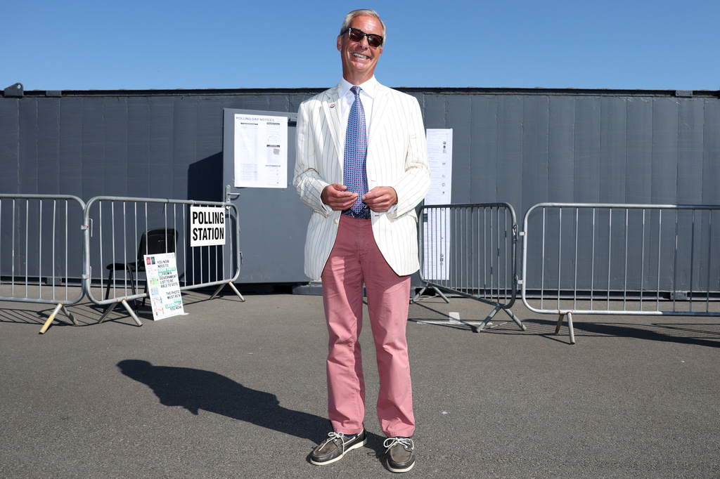 Britain's Reform UK party leader Nigel Farage arrives at a polling station in Walton on the Naze, Thursday, Aug. 13, 2026 to cast his vote for the Clacton on Sea by-election.(AP Photo/Richard Pelham)