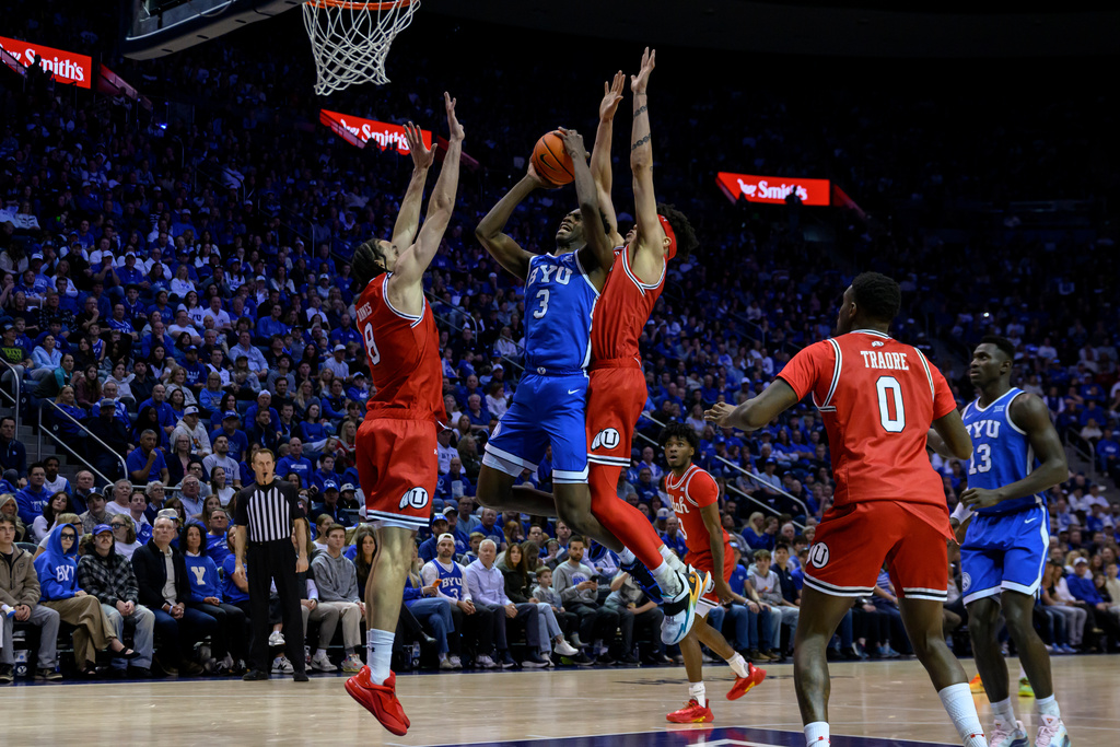BYU forward AJ Dybantsa (3) shoots over Utah forward Keanu Dawes (8) during the first half of an NCAA college basketball game, Saturday, Jan. 24, 2026, in Provo, Utah. (AP Photo/Tyler Tate)