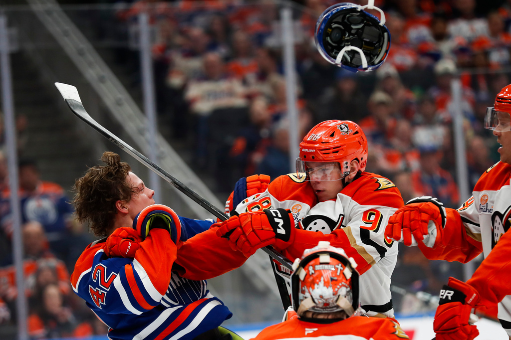 Anaheim Ducks' Pavel Mintyukov (98) battles against Edmonton Oilers' Kasperi Kapanen (42) during second period NHL playoff action in Edmonton on Wednesday, April 22, 2026. (Codie McLachlan/The Canadian Press via AP)