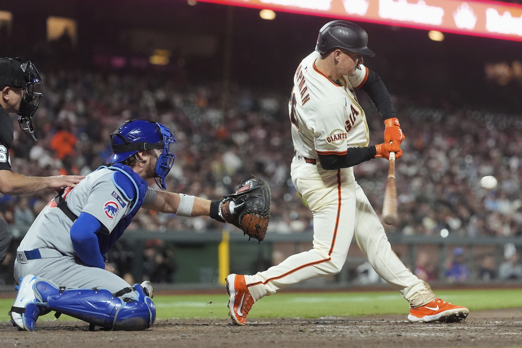 San Francisco Giants' Matt Chapman, right, hits an RBI single in front of Chicago Cubs catcher Carson Kelly during the fifth inning of a baseball game in San Francisco, Wednesday, Aug. 27, 2025. (AP Photo/Jeff Chiu)