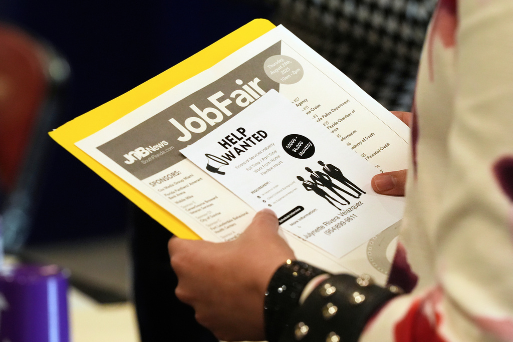 FILE - A job seeker waits to talk to a recruiter at a job fair Aug. 28, 2025, in Sunrise, Fla. (AP Photo/Marta Lavandier, File)