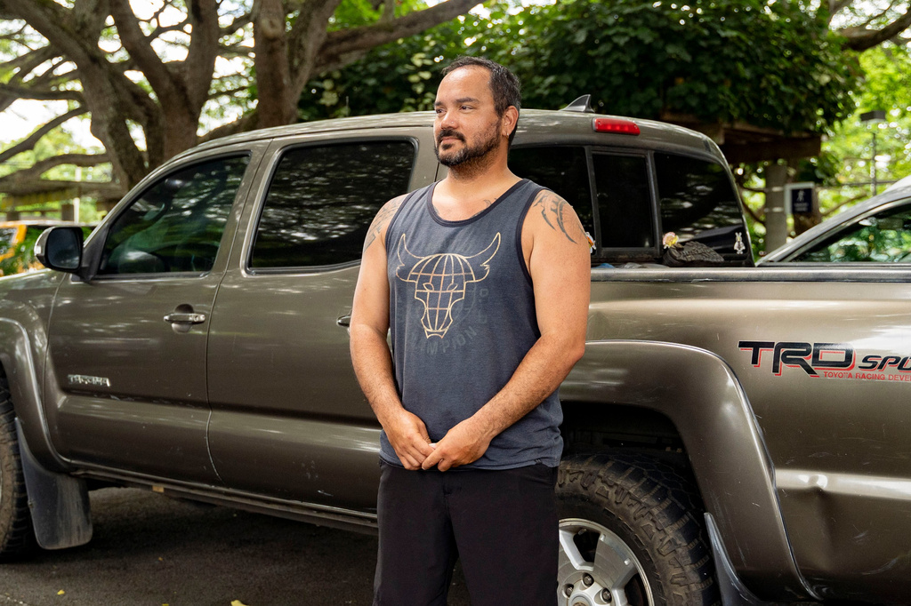 Kimeona Kane poses in front of his pickup truck, Friday, July 17, 2026, in Kailua, Hawaii. (AP Photo/Mengshin Lin)