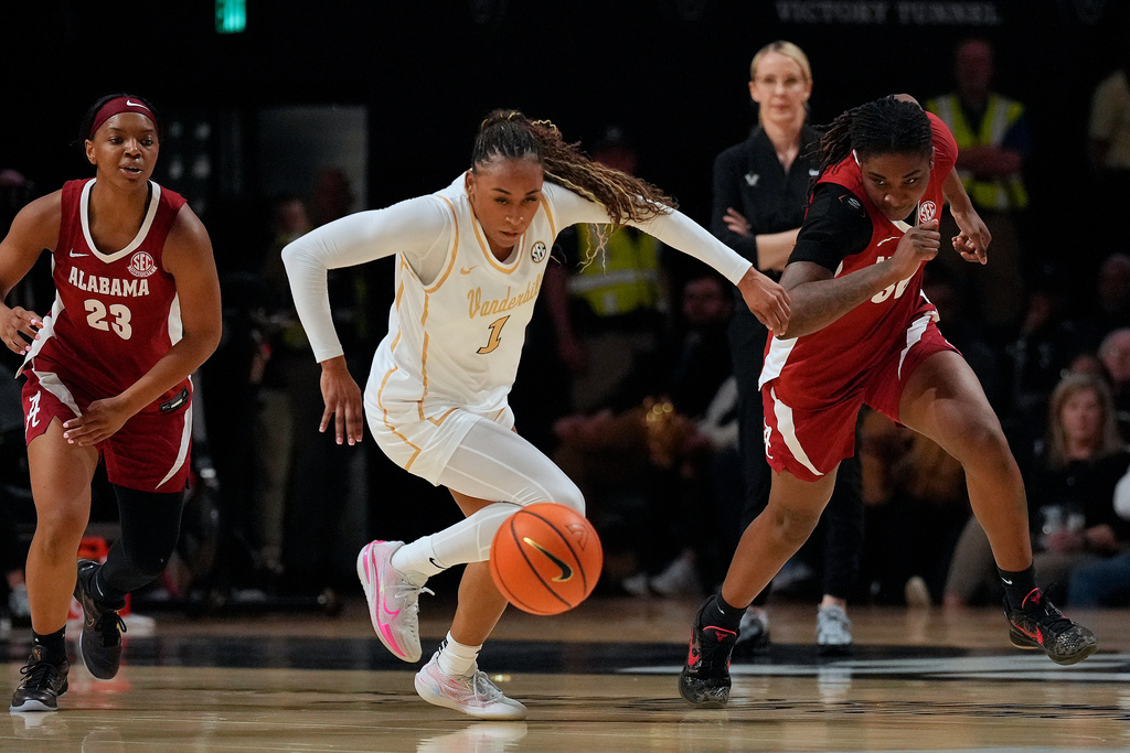 Vanderbilt's Mikayla Blakes (1) chases the ball with Alabama's Jessica Timmons (23) and Alancia Ramsey, right, in the first half of an NCAA college basketball game Thursday, Feb. 26, 2026, in Nashville, Tenn. (AP Photo/Mark Humphrey)