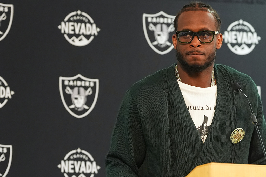 Las Vegas Raiders quarterback Geno Smith talks after an NFL football game against the Denver Broncos, Thursday, Nov. 6, 2025, in Denver. (AP Photo/David Zalubowski)