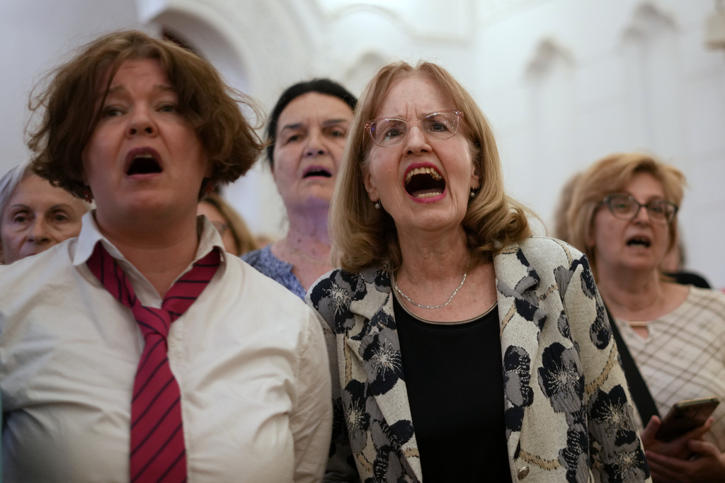 Choir members perform a song during a practice in Belgrade, Serbia, Wednesday, April 15, 2026. (AP Photo/Darko Vojinovic)