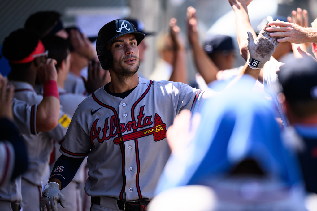 Atlanta Braves first baseman Matt Olson is greeted by teammates after scoring during the third inning of a baseball game against the Los Angeles Angels, Wednesday, April 8, 2026, in Anaheim, Calif. (AP Photo/William Liang)