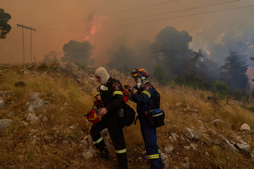 Firefighters operate on Mount Kithairon near Porto Germeno, northwest of Athens, Greece, Monday, Aug. 3, 2026. (AP Photo/Petros Giannakouris)