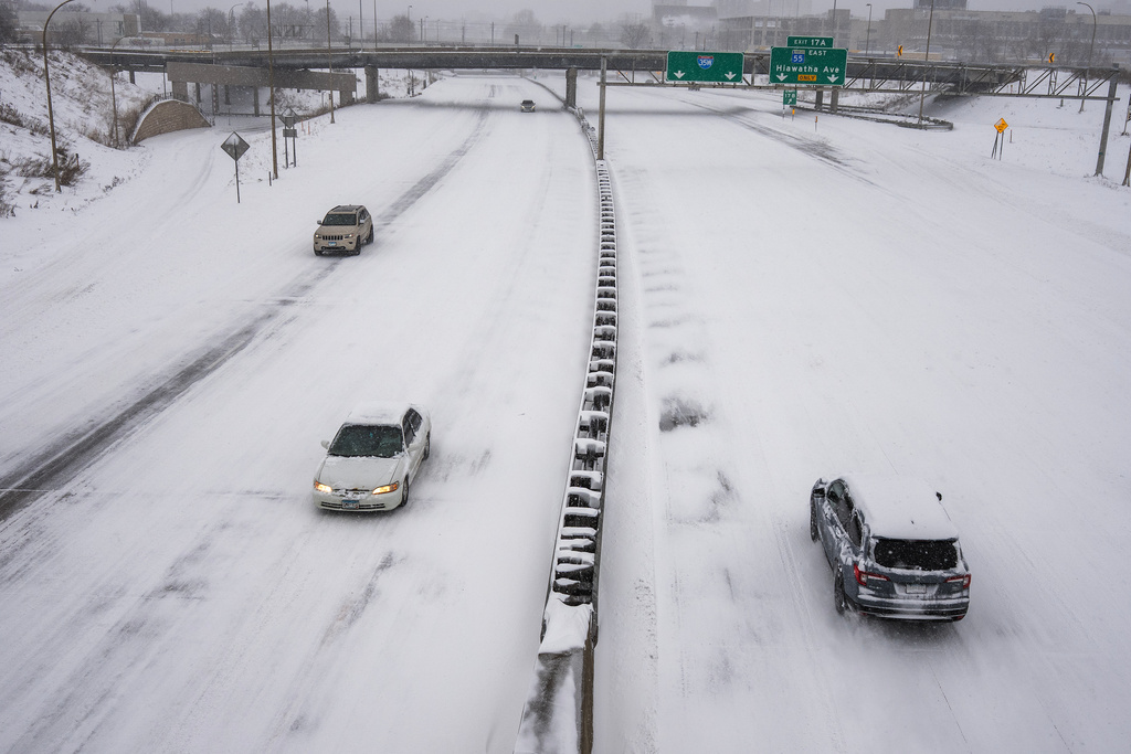 People drive on a snow-covered freeway during a snow storm Sunday, March 15, 2026, in Minneapolis. (Richard Tsong-Taatarii/Minnesota Star Tribune via AP)