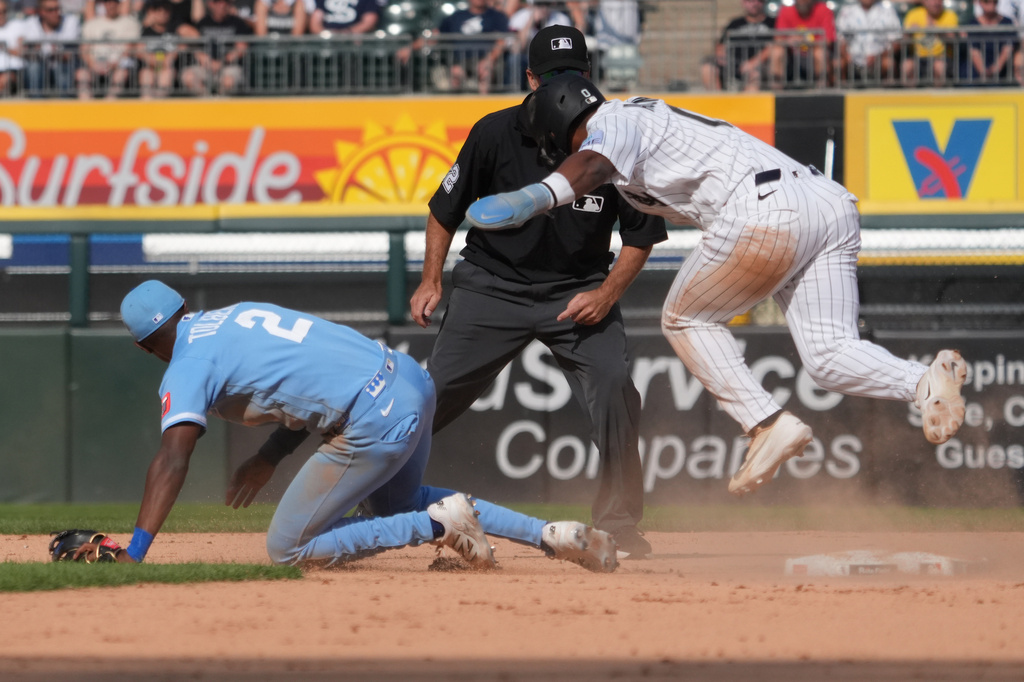 Chicago White Sox' Luisangel Acuña (0) is safe at second base as Kansas City Royals second baseman Tyler Tolbert (2) can't handle an errant throw during the seventh inning of a baseball gam,e Saturday, June 27, 2026, in Chicago. (AP Photo/David Banks)