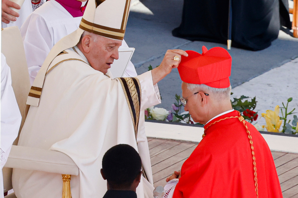 FILE - Newly elected Cardinal Robert Francis Prevost, Prefect of the Dicastery for Bishops, right, receives his biretta from Pope Francis as he is elevated in St. Peter's Square at The Vatican, Sept. 30, 2023. (AP Photo/Riccardo De Luca, File)
