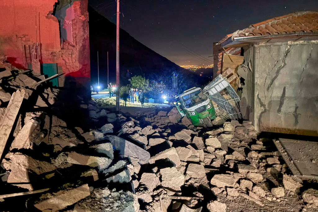 A motor tricycle is stuck amid the debris of homes that collapsed after an earthquake struck Pumpuya, Peru, Sunday, July 19, 2026. ( AP Photo/Jhefry Sedano)