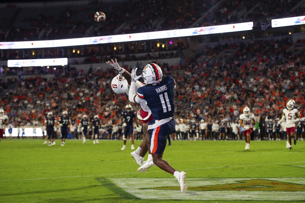 Virginia wide receiver Trell Harris (11) catches a touchdown pass over Stanford cornerback Collin Wright (6) during the first half of an NCAA college football game Saturday, Sept. 20, 2025, in Charlottesville, Va. (AP Photo/Mike Caudill)