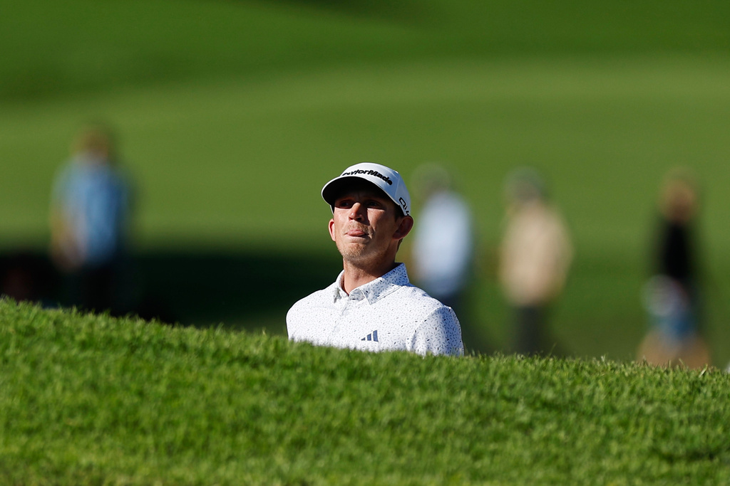 Jacob Bridgeman prepares to hit from a bunker on the 14th hole during the third round of the Genesis Invitational golf tournament at Riviera Country Club, Saturday, Feb. 21, 2026, in the Pacific Palisades area of Los Angeles. (AP Photo/Caroline Brehman )