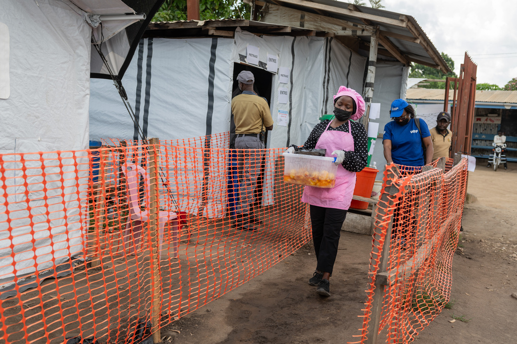 Kavugho Hortense, a cook, delivers meals to the medical staff and Ebola patients at the Evangelical Medical Center (CEM) in Bunia, Congo, Monday, June 1, 2026. (AP Photo/Moses Sawasawa)