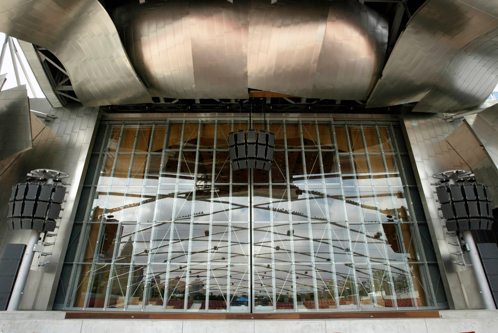 FILE - A trellis of curved steel pipes are reflected in glass doors on the stage area at the new band shell in Chicago's Millennium Park, July 7, 2004. The $52 million band shell, with its stage surrounded by billowing ribbons of stainless steel, was designed by famed architect Frank Gehry. (AP Photo/Nam Y. Huh, File)