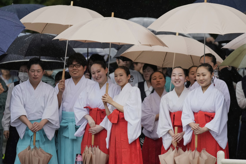 Officials in the Shinto priesthood watch a Japanese traditional dance in celebration of Mihishirogi Hoeishiki, a ceremony of the Shikinen Sengu ritual to rebuild main structures of the Ise Jingu shrine complex for Shinto deities, in Ise, central Japan, Monday, June 9, 2025. (AP Photo/Hiro Komae)