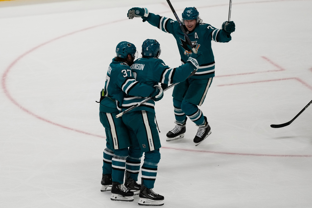 San Jose Sharks defenseman Sam Dickinson, middle, is congratulated by defenseman Timothy Liljegren (37) and San Jose Sharks center Tyler Toffoli after scoring against the Detroit Red Wings during the third period of an NHL hockey game in San Jose, Calif., Sunday, Nov. 2, 2025. (AP Photo/Jeff Chiu)