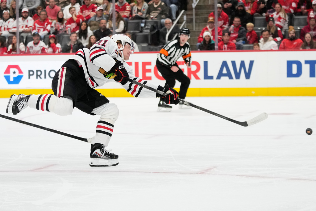 Chicago Blackhawks center Oliver Moore shoots during the first period of an NHL hockey game against the Detroit Red Wings, Sunday, Nov. 9, 2025, in Detroit. (AP Photo/Ryan Sun)