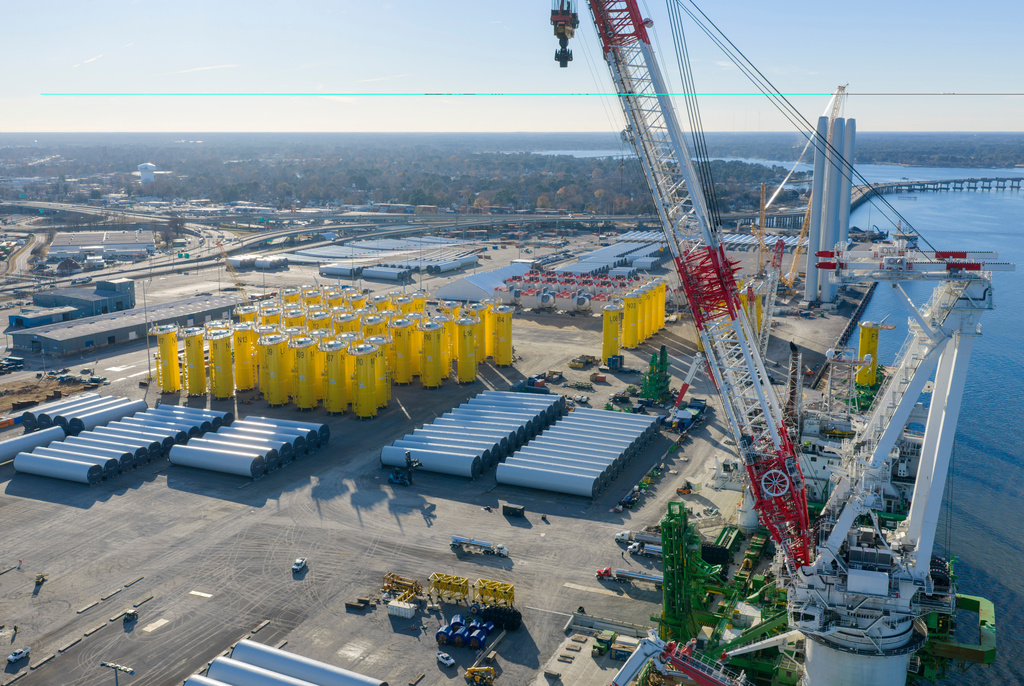 Wind turbine bases, generators and blades are positioned along with support ships at The Portsmouth Marine terminal at the staging area for Dominion Energy's wind turbine project Monday Dec. 22, 2025, in Portsmouth, Va. (AP Photo/Steve Helber)