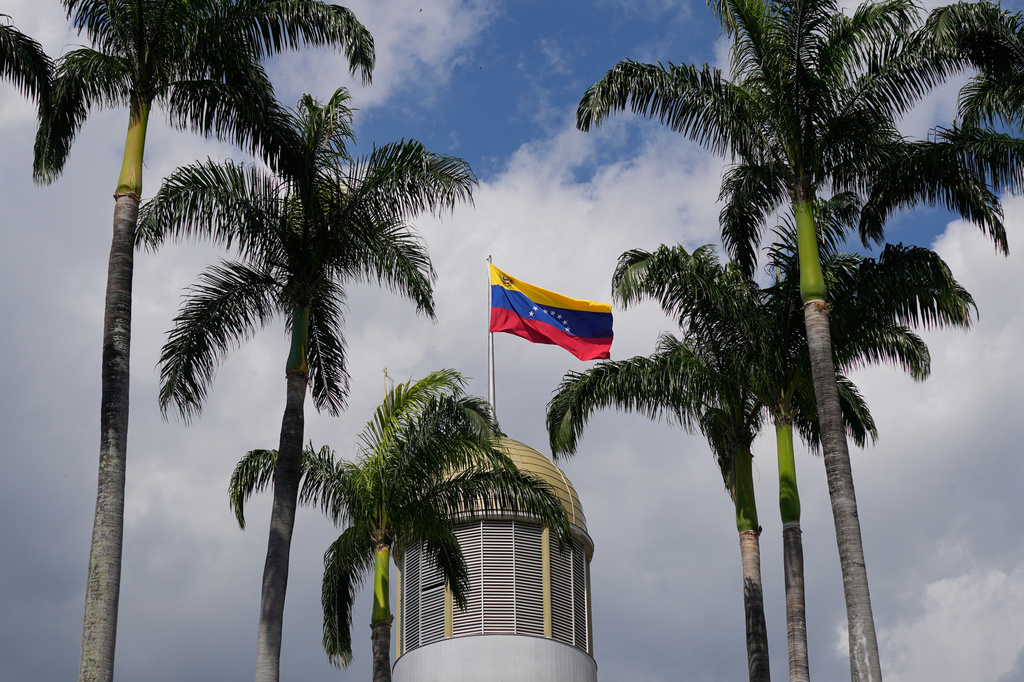 FILE - A Venezuelan flag waves in the wind atop the National Assembly palace in Caracas, Venezuela, Jan. 20, 2026. (AP Photo/Matias Delacroix, File)