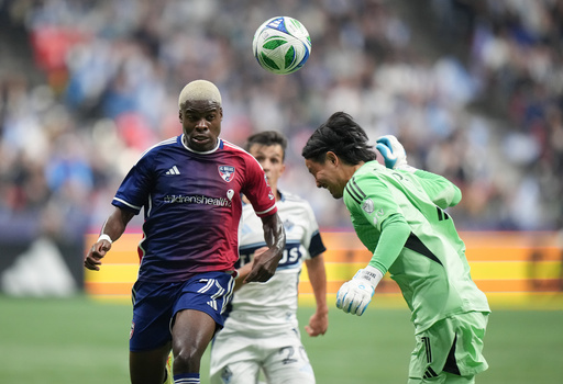 FC Dallas' Bernard Kamungo, left, and Vancouver Whitecaps' goalkeeper Yohei Takaoka, right, vie for the ball during the first half in Game 1 in the first round of MLS soccer's Western Conference playoffs in Vancouver, British Columbia, Sunday, Oct. 26, 2025. (Darryl Dyck/The Canadian Press via AP) FC Dallas' Bernard Kamungo, left, and Vancouver Whitecaps' goalkeeper Yohei Takaoka, right, vie for the ball during the first half in Game 1 in the first round of MLS soccer's Western Conference playoffs in Vancouver, British Columbia, Sunday, Oct. 26, 2025. (Darryl Dyck/The Canadian Press via AP)