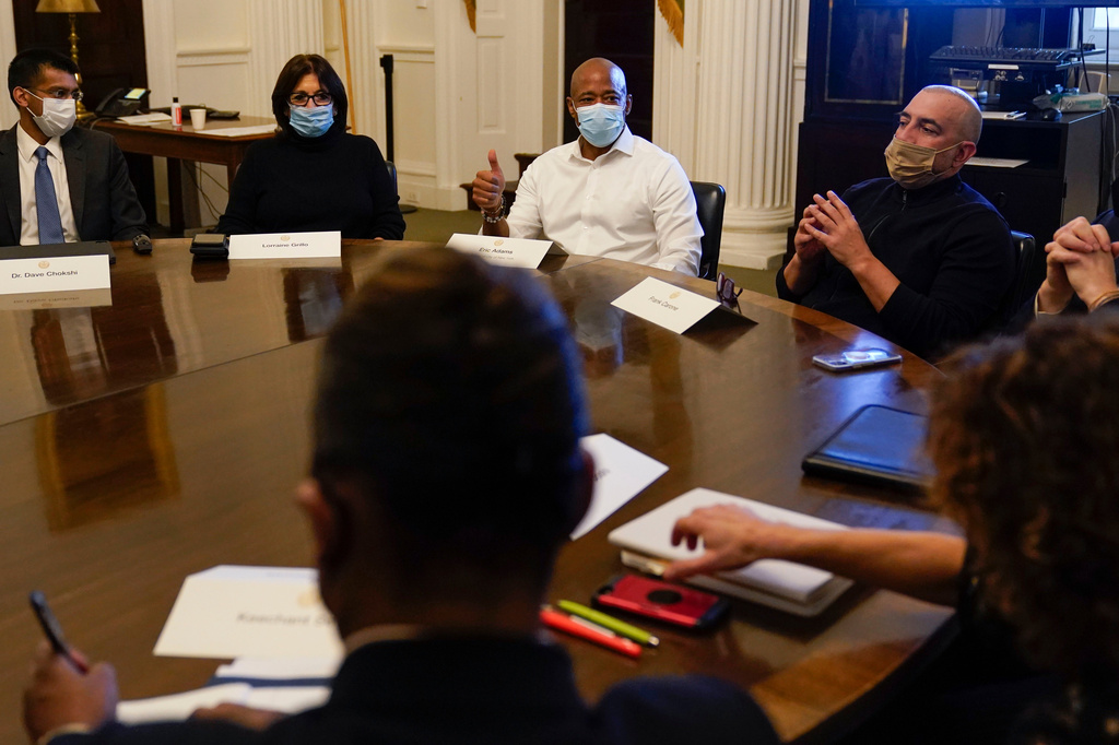 FILE - New York City Mayor Eric Adams, center, speaks during a cabinet meeting on his first day in office in New York, Jan. 1, 2022. To Adams' right is his Chief of Staff Frank Carone. (AP Photo/Seth Wenig, File)